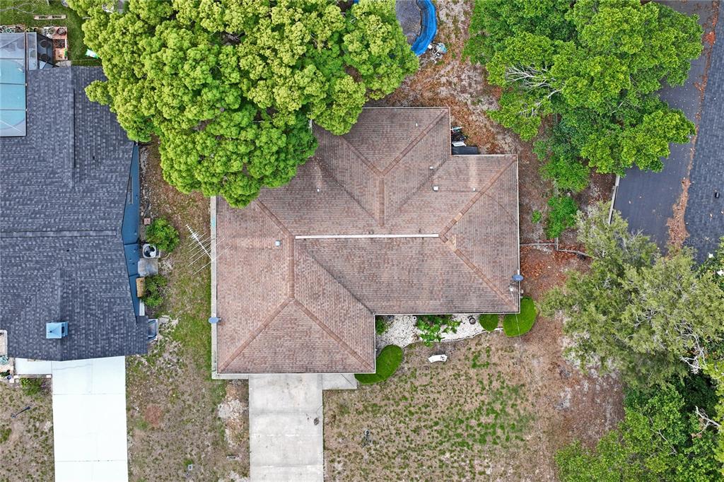 11122 Maderia Street Spring Hill, FL 34609 - Photo 48 of 49 an aerial view of a house with potted plants and large trees