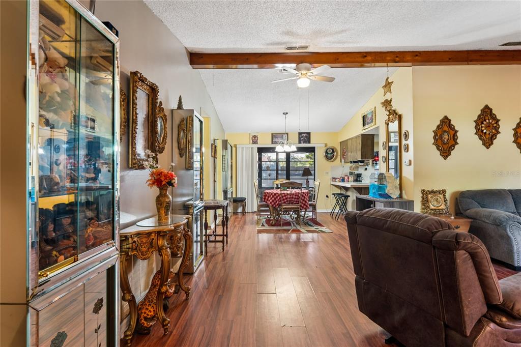 11122 Maderia Street Spring Hill, FL 34609 - Photo 6 of 49 a living room with furniture and wooden floor