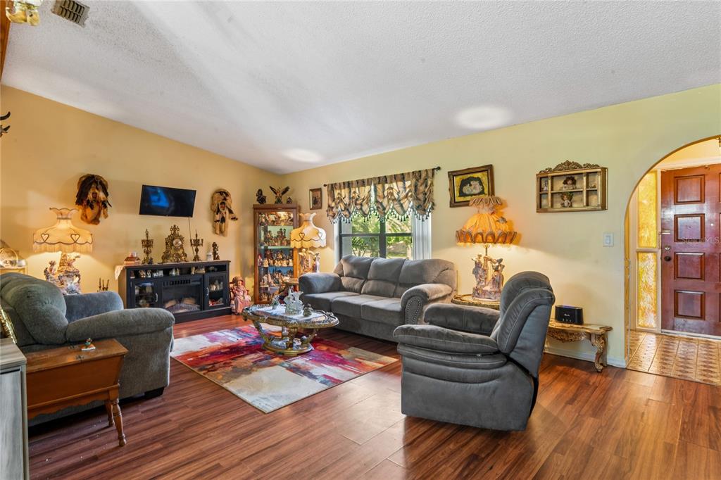 11122 Maderia Street Spring Hill, FL 34609 - Photo 8 of 49 a living room with furniture and a wooden floor