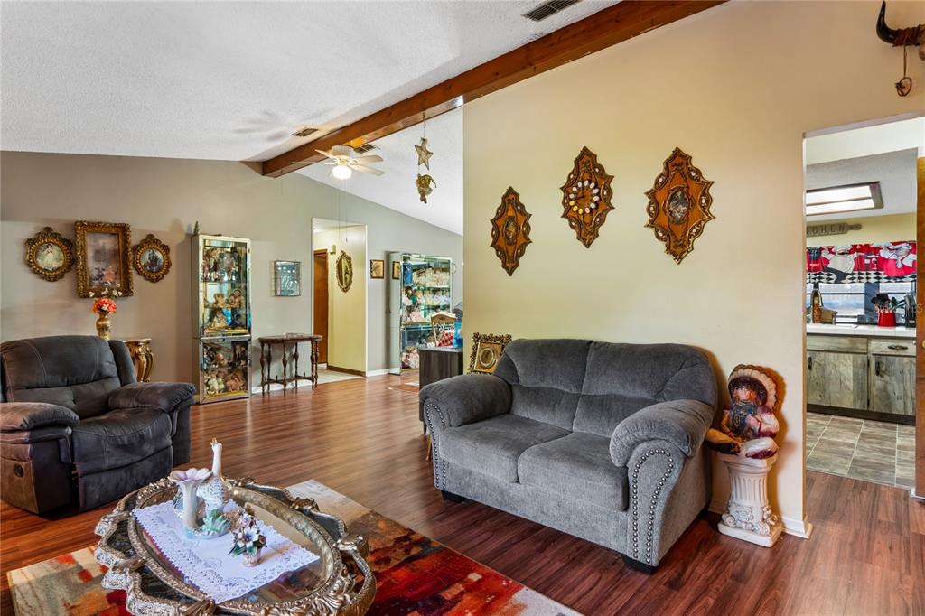 11122 Maderia Street Spring Hill, FL 34609 - Photo 9 of 49 a living room with furniture and wooden floor