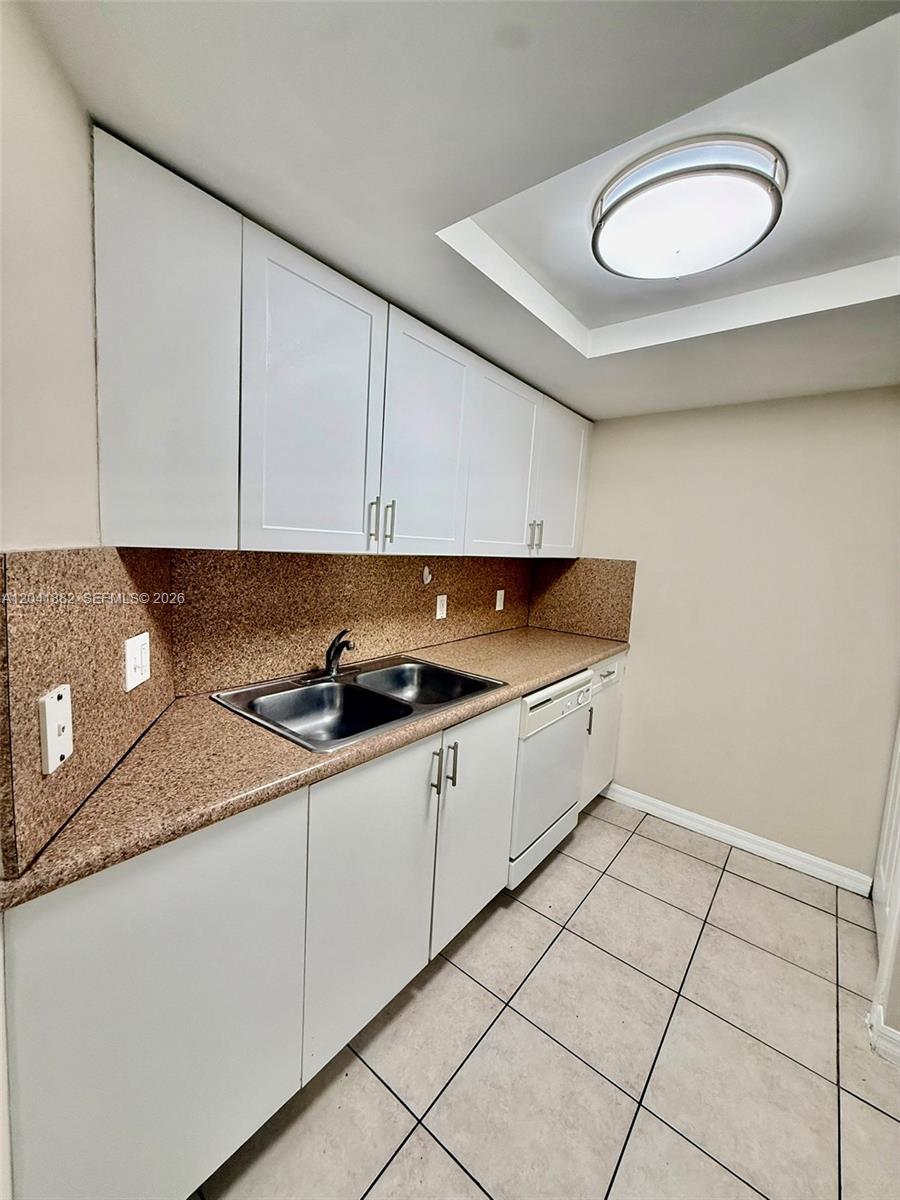 2475 Northwest 16th St Road, Unit 418 Miami, FL 33125 - Photo 20 of 27 a kitchen that has a sink and a stove