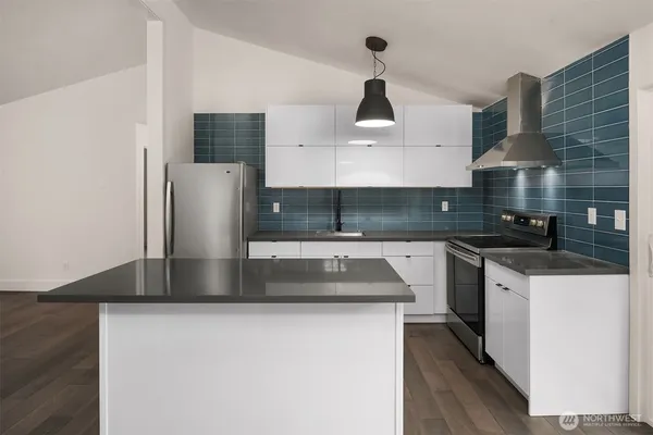 a kitchen with stainless steel appliances a sink and a stove