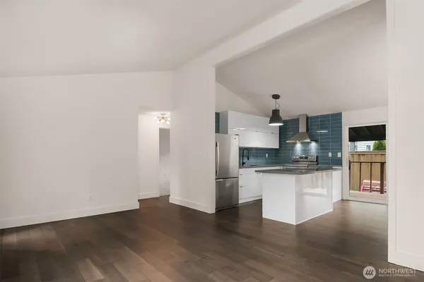 a kitchen with stainless steel appliances granite countertop a refrigerator and a stove top oven