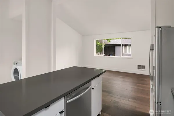 a kitchen with a sink and a refrigerator