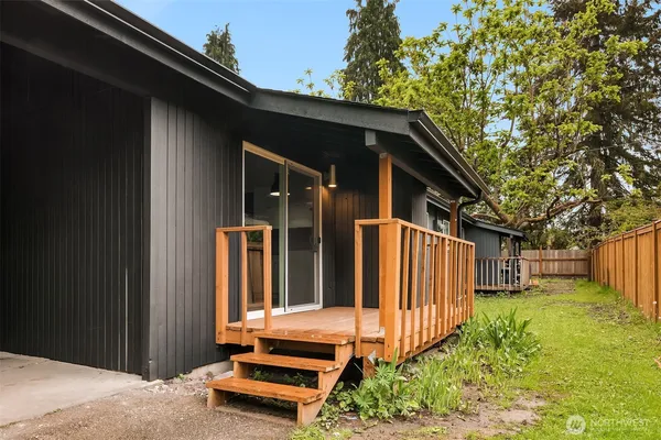 a backyard of a house with table and chairs