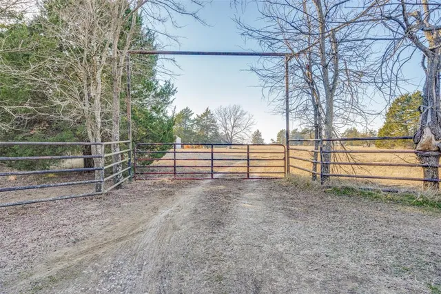 a view of a yard with wooden fence