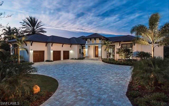 16767 Prato Way Naples, FL 34110 - Photo 1 of 2 front view of a house with a yard