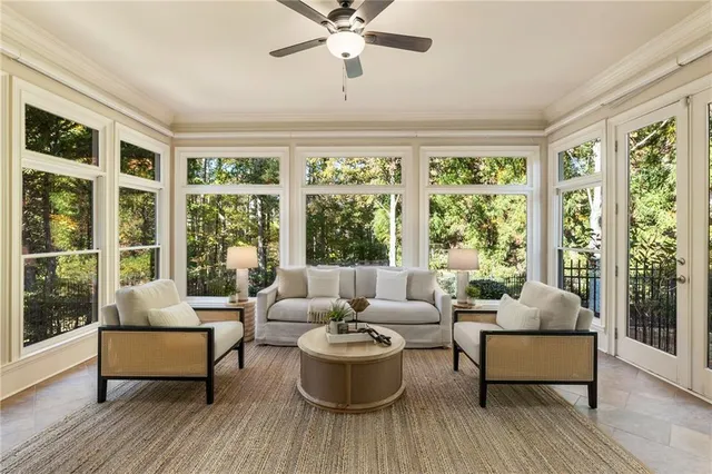 a living room with furniture a rug and a chandelier