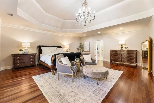 a bedroom with a bed window and a flat screen tv