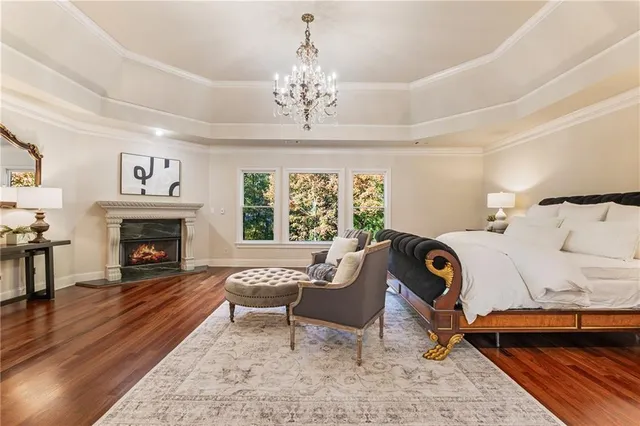 a bathroom with a granite countertop sink a toilet a mirror a bathtub and shower