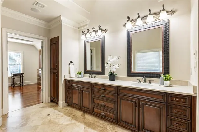a bathroom with a granite countertop sink toilet mirror vanity and bathtub