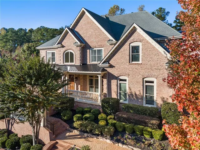 a kitchen with a stove a sink a dining table and chairs