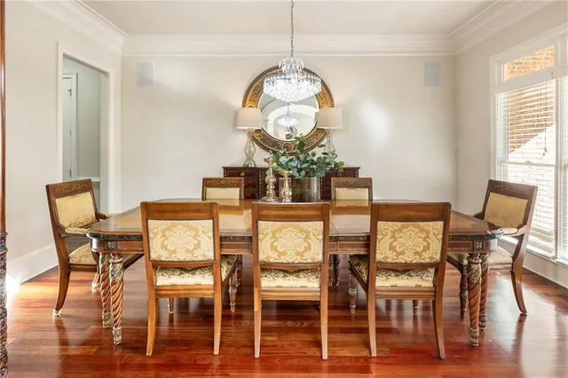 a living room with furniture large window and wooden floor