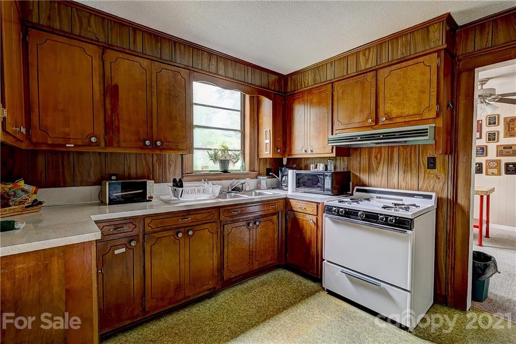 202 West Main Street Cherryville, NC 28021 - Photo 10 of 17 a kitchen with a stove a sink and a cabinets