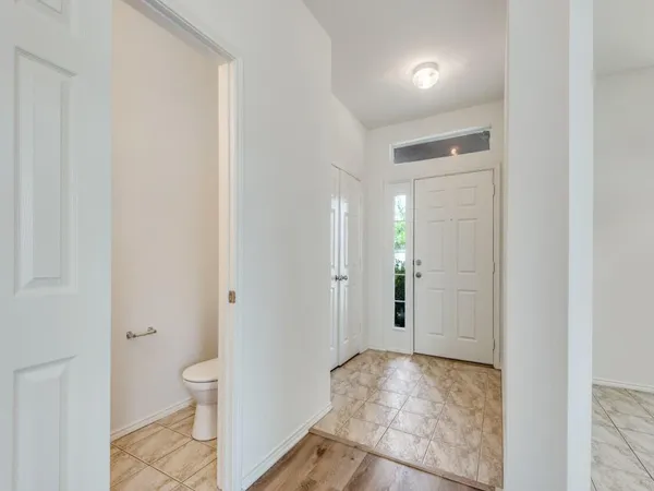 a spacious bathroom with a granite countertop toilet and a sink
