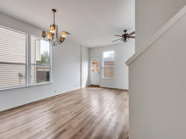 a view of a livingroom with a ceiling fan and window