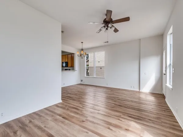 a view of a livingroom with a ceiling fan and wooden floor