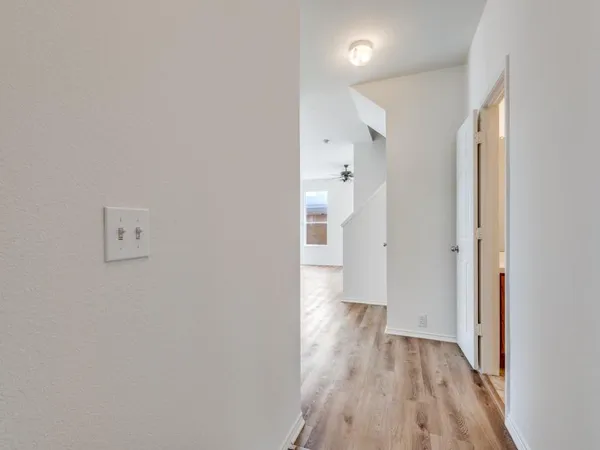 a view of a hallway with wooden floor