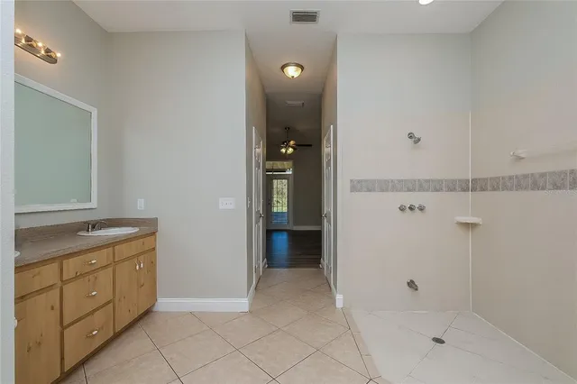 a bathroom with a shower and a sink