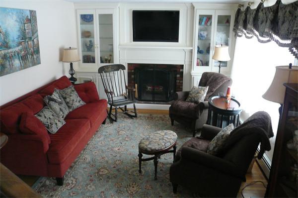23 Whittier Road Billerica, MA 01821 - Photo 13 of 25 a living room with furniture a flat screen tv and a fireplace