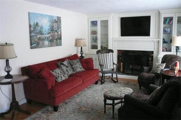 23 Whittier Road Billerica, MA 01821 - Photo 14 of 25 a living room with furniture a flat screen tv and a fireplace