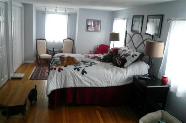 23 Whittier Road Billerica, MA 01821 - Photo 20 of 25 a bed sitting in a bedroom next to a window with tv