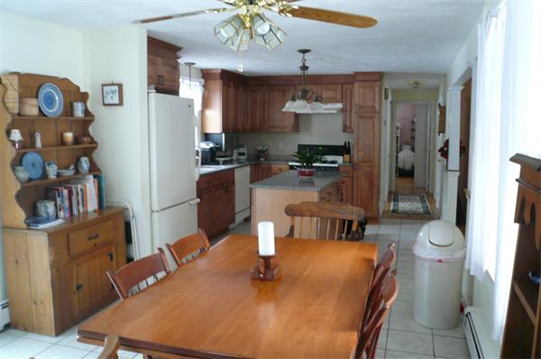 23 Whittier Road Billerica, MA 01821 - Photo 7 of 25 a kitchen with a table and chairs in it
