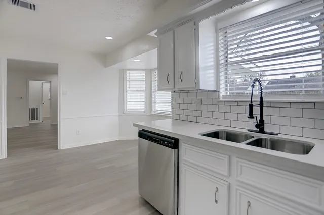 a kitchen with a sink and cabinets