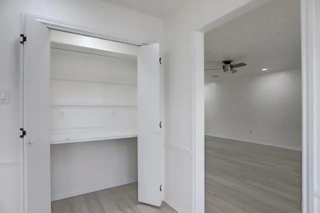 a view of walk in closet with empty racks