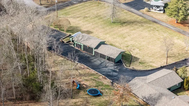 a view of a kitchen with a refrigerator and wooden floor