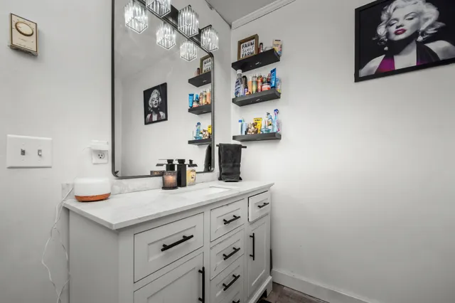 a bedroom with furniture and a flat screen tv