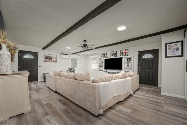 a bedroom with furniture and large windows