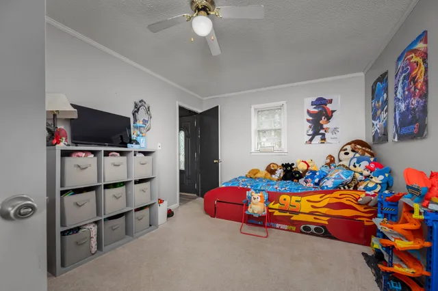 a view of a livingroom with a hardwood floor and a ceiling fan