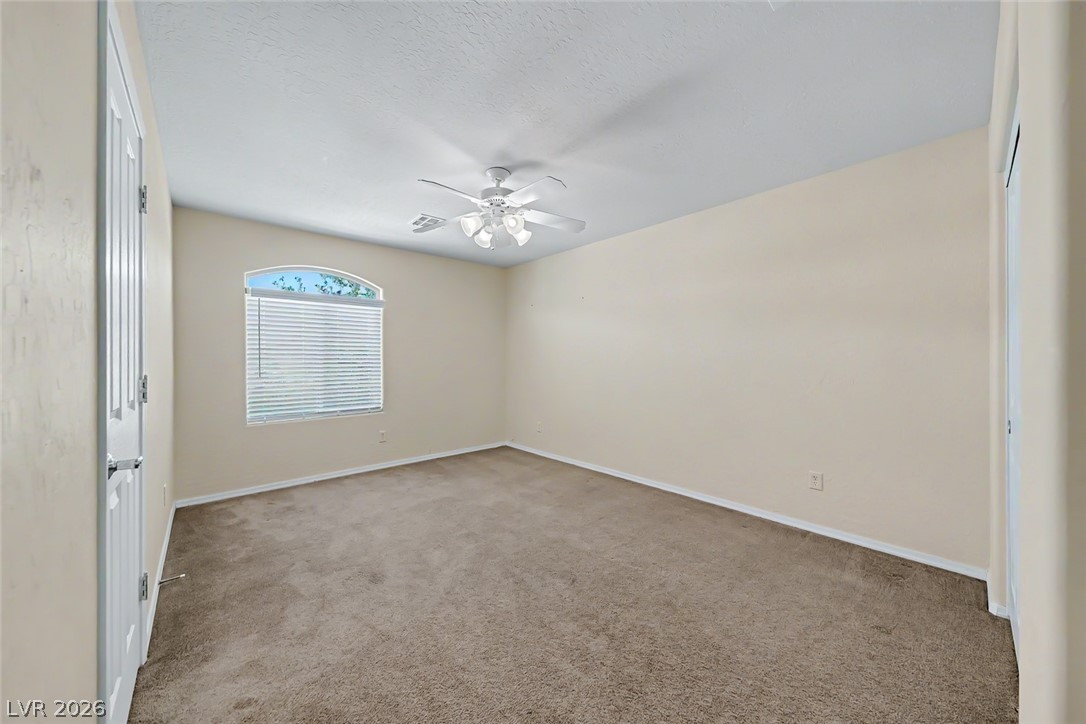 2356 Rue Bienville Way Henderson, NV 89044 - Photo 13 of 20 This airy bedroom offers a tranquil retreat with ample space and natural light.