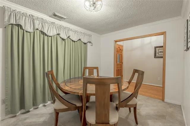 a view of a dining room with furniture and a chandelier
