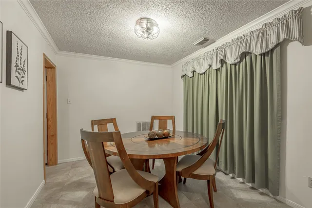 a view of a dining room with furniture and a chandelier
