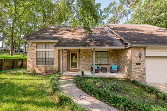 a view of a house with backyard porch and sitting area