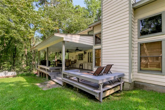 a view of a house with backyard and sitting area