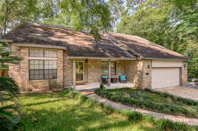a front view of house with yard and outdoor seating