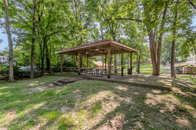 a view of a backyard with a table and chairs under an umbrella