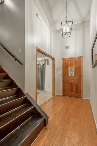 a view of an entryway with wooden floor and livingroom view