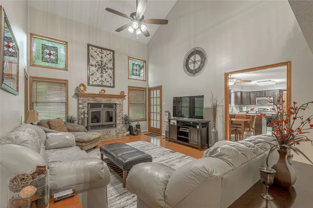 a living room with furniture a fireplace and a flat screen tv