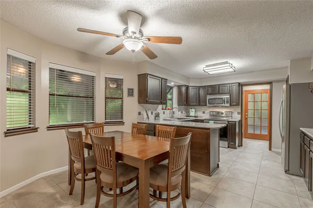 a dining table with chairs and chandelier