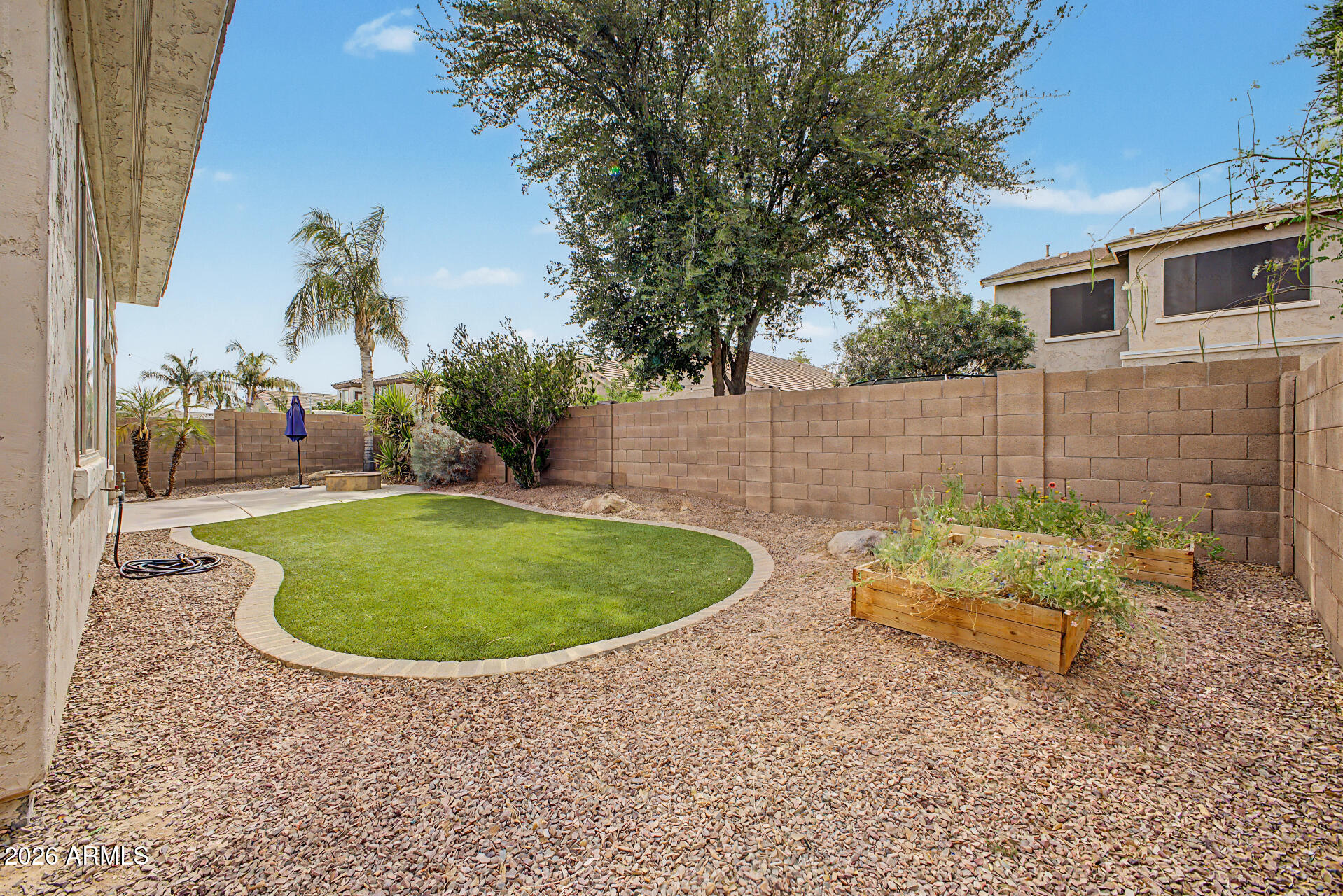 4272 East Buckboard Road Gilbert, AZ 85297 - Photo 34 of 37 a backyard of a house with outdoor seating