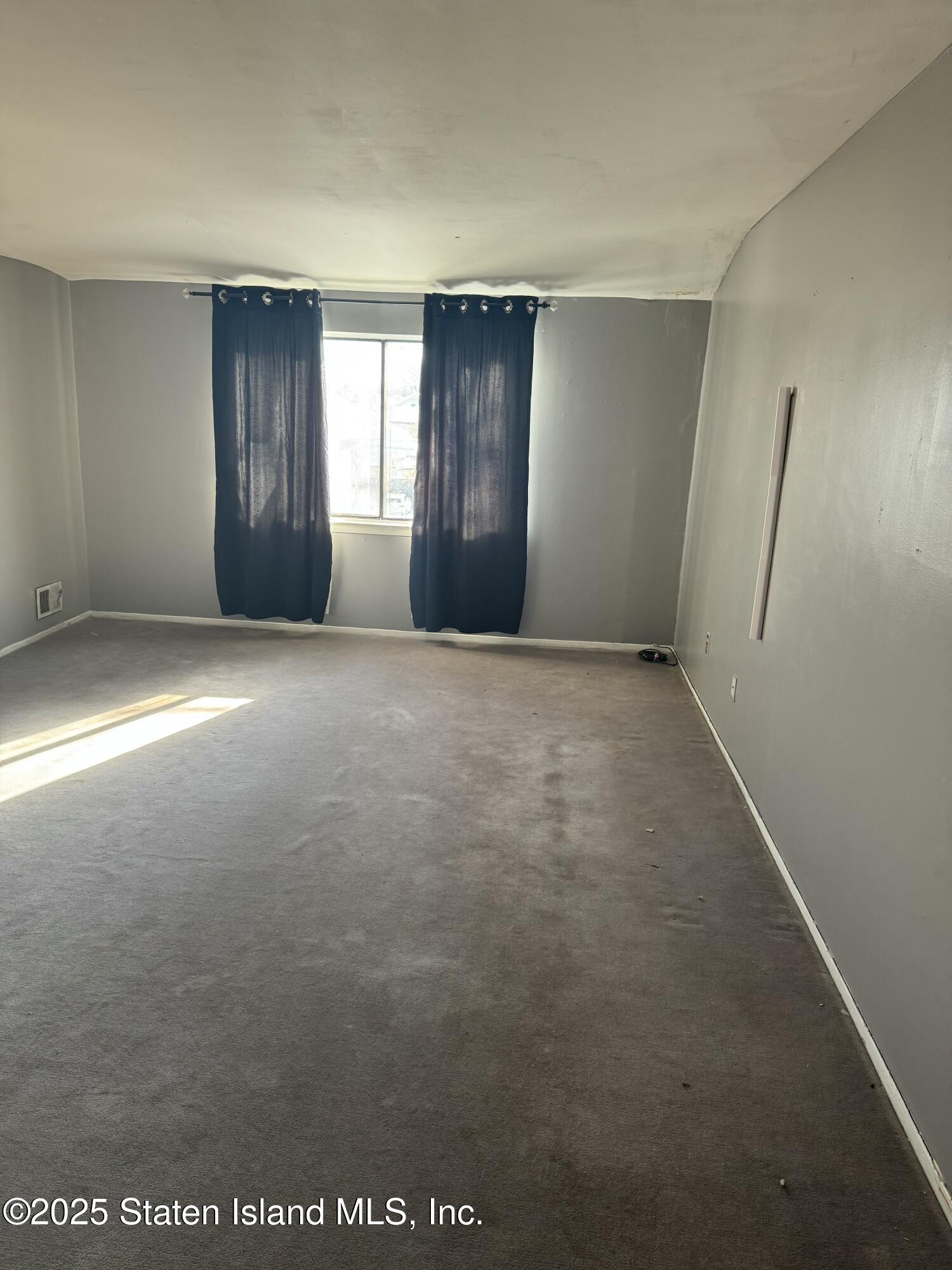 630 Ramona Avenue Staten Island, NY 10309 - Photo 5 of 9 a view of an empty room with a window