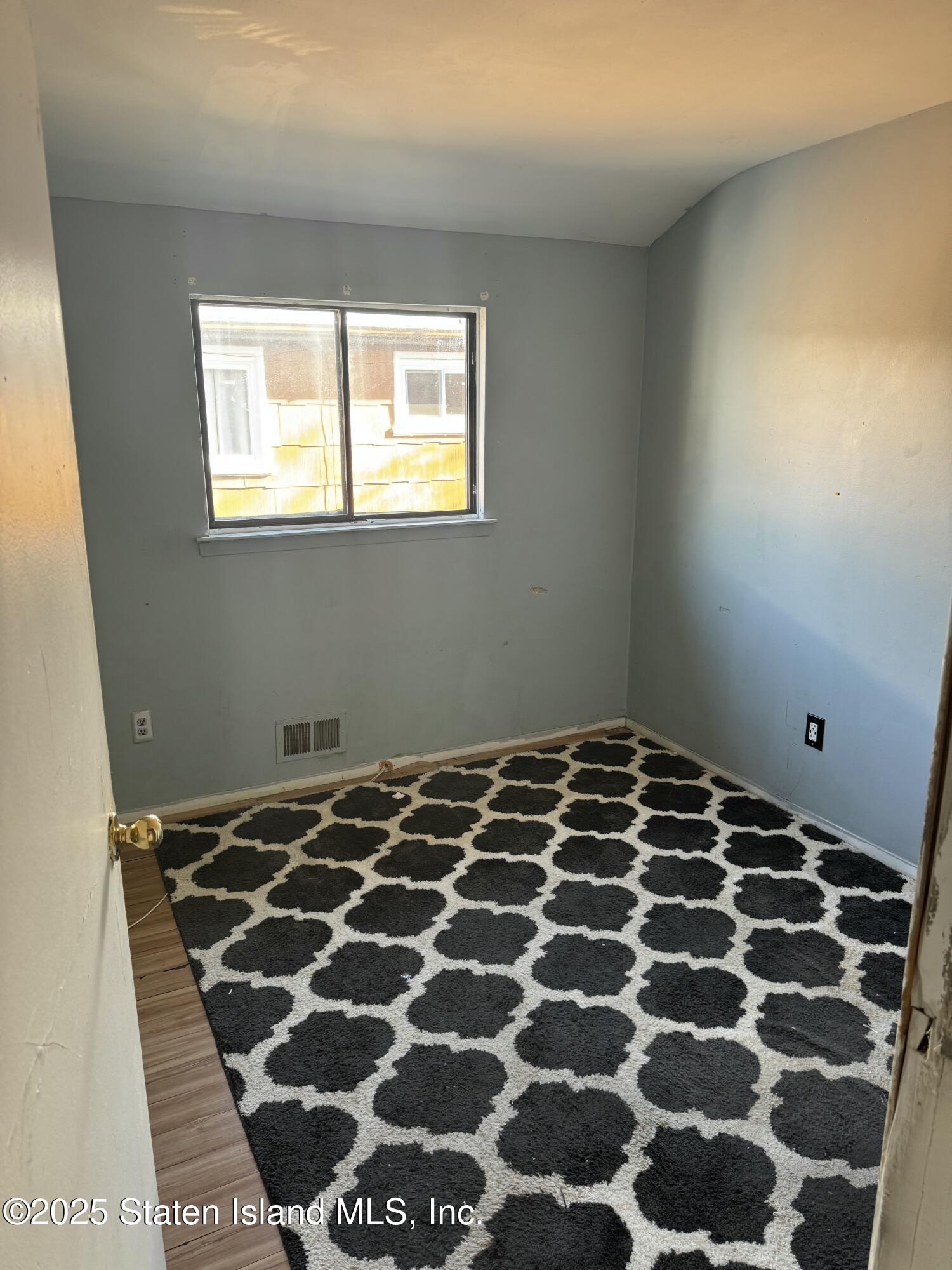 630 Ramona Avenue Staten Island, NY 10309 - Photo 7 of 9 a bedroom with a bed