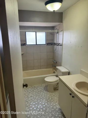 a bathroom with a toilet a sink and bathtub