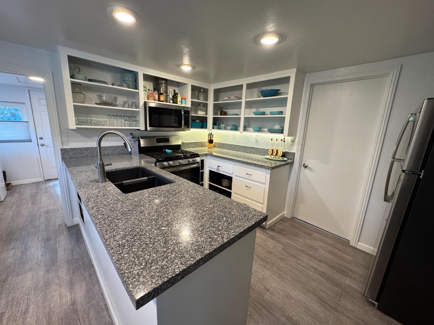 1777 Circle Drive Isleton, CA 95641 - Photo 4 of 20 a kitchen with kitchen island granite countertop a sink stove and refrigerator