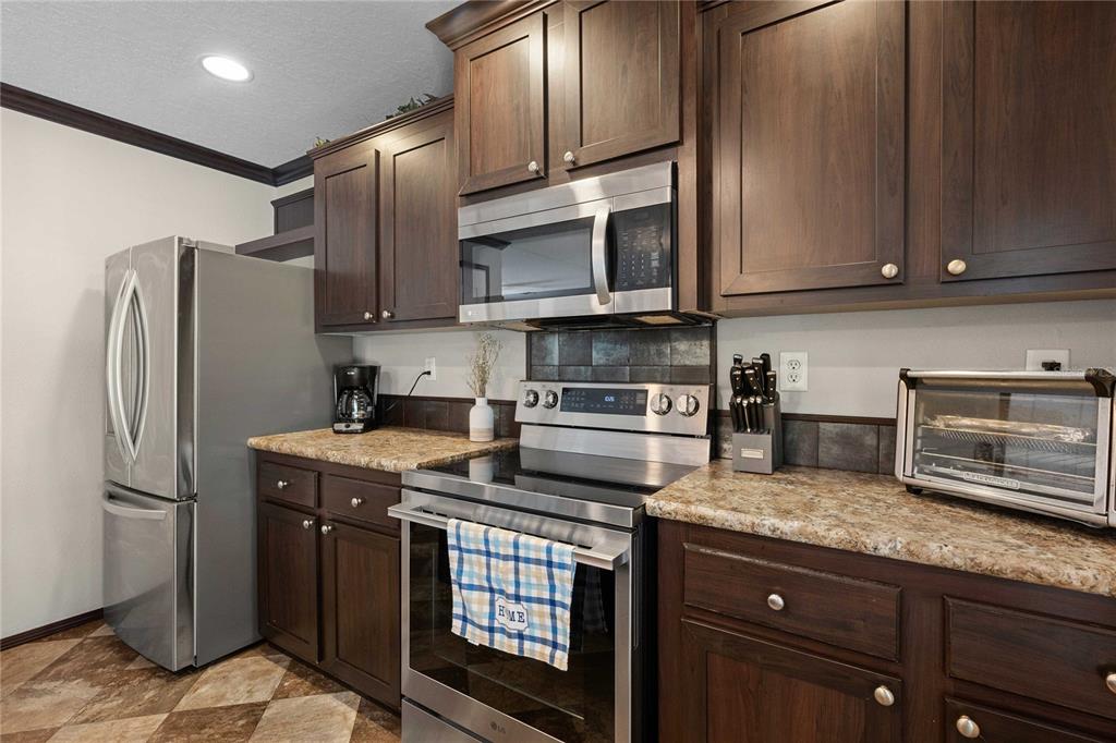 3283 Neff Lake Road Brooksville, FL 34602 - Photo 13 of 37 a kitchen with stainless steel appliances granite countertop a refrigerator stove and sink