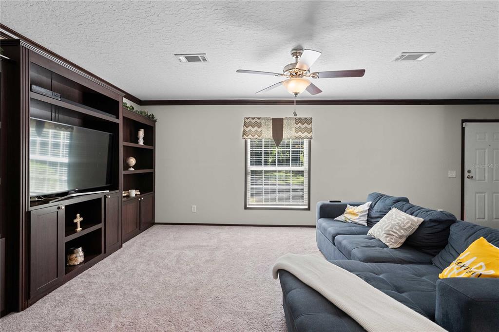 3283 Neff Lake Road Brooksville, FL 34602 - Photo 17 of 37 a living room with furniture and a flat screen tv